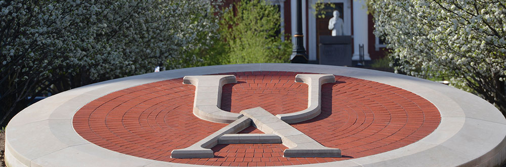 A decorative UA in stone is located in the center of campus.